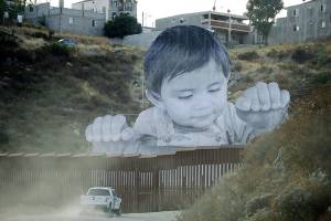 Giant portrait of toddler peers over US-Mexico border wall