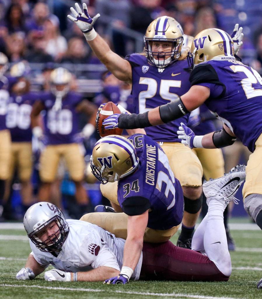 Washington&rsquo;s Sean Constantine forces a fumble by Montana&rsquo;s Jeremy Calhoun Saturday night at Husky Stadium in Seattle on September 9, 2017. Washington defeated Montana 63-7. (Kevin Clark / The Herald)