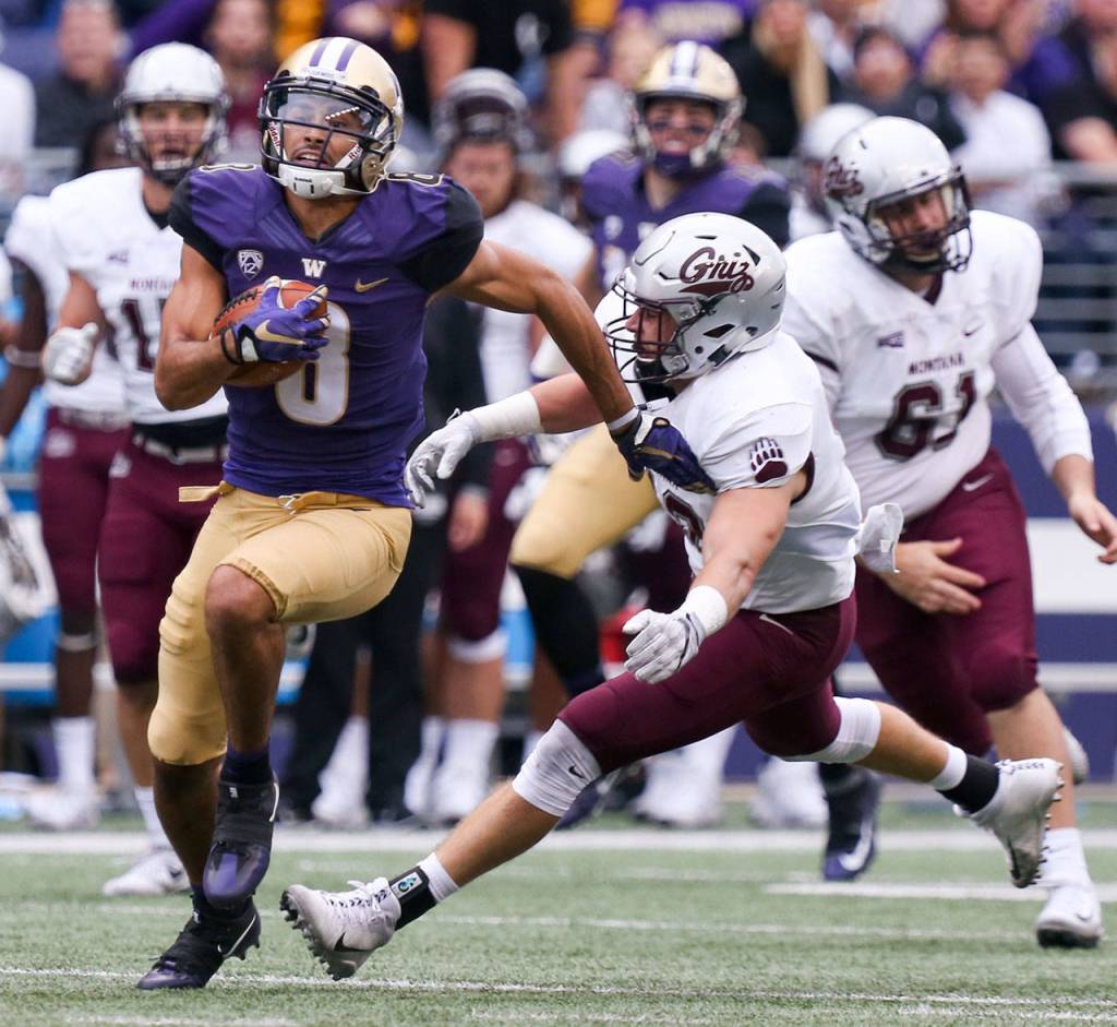 Washington&rsquo;s Dante Pettis returns a punt for a touchdown Saturday night at Husky Stadium in Seattle on September 9, 2017. Washington defeated Montana 63-7. (Kevin Clark / The Herald)