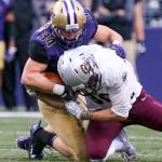 Washington&rsquo;s Sean Constantine forces a fumble by Montana&rsquo;s Jeremy Calhoun Saturday night at Husky Stadium in Seattle on September 9, 2017. Washington defeated Montana 63-7. (Kevin Clark / The Herald)