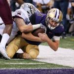 Washington&rsquo;s Jake Browning is stopped short the goal line by Montana&rsquo;s Josh Buss Saturday night at Husky Stadium in Seattle on September 9, 2017. Washington defeated Montana 63-7. (Kevin Clark / The Herald)