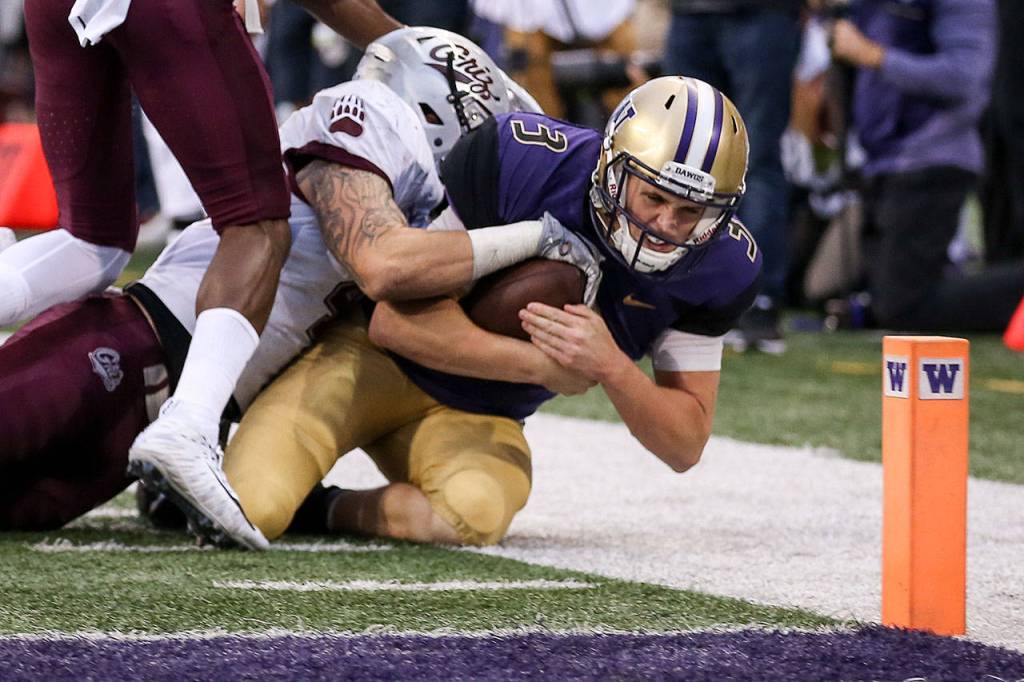 Washington&rsquo;s Jake Browning is stopped short the goal line by Montana&rsquo;s Josh Buss Saturday night at Husky Stadium in Seattle on September 9, 2017. Washington defeated Montana 63-7. (Kevin Clark / The Herald)