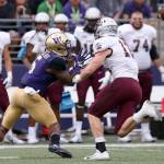 Washington&rsquo;s Chico McClatcher back tracks for a reception with Montana&rsquo;s Josh Sandry Saturday night at Husky Stadium in Seattle on September 9, 2017. Washington defeated Montana 63-7. (Kevin Clark / The Herald)
