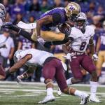 Washington&rsquo;s Quinten Pounds leaps a tackle attempts by Montana&rsquo;s Justin Strong Saturday night at Husky Stadium in Seattle on September 9, 2017. Washington defeated Montana 63-7. (Kevin Clark / The Herald)