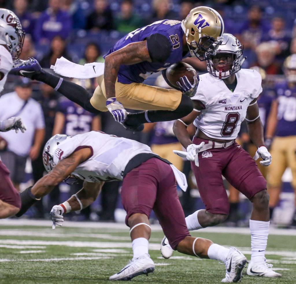 Washington&rsquo;s Quinten Pounds leaps a tackle attempts by Montana&rsquo;s Justin Strong Saturday night at Husky Stadium in Seattle on September 9, 2017. Washington defeated Montana 63-7. (Kevin Clark / The Herald)