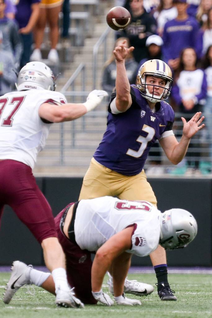 Washington&rsquo;s Jake Browning throws a pass despite Montana defensive pressure Saturday night at Husky Stadium in Seattle on September 9, 2017. Washington defeated Montana 63-7. (Kevin Clark / The Herald)