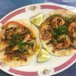 A fish taco and a shrimp taco comes with sauteed peppers, onion and mushroom and a whole lot of flavor at Ade&rsquo;s Mexican Deli in Everett. (Ben Watanabe / The Herald)