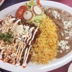 Chicken enchiladas with red sauce, cheese and crema, plus rice and beans makes for a seriously filling dish at Ade&rsquo;s Mexican Deli. (Ben Watanabe / The Herald)
