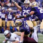 Washington&rsquo;s Sean Constantine forces a fumble by Montana&rsquo;s Jeremy Calhoun during a game Sept. 9, 2017, at Husky Stadium in Seattle. Washington defeated Montana 63-7. (Kevin Clark / The Herald)