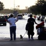 Evacuees on Monday leave Germain Arena, which was used as an evacuation shelter for Hurricane Irma in Estero, Florida. (AP Photo/Gerald Herbert)