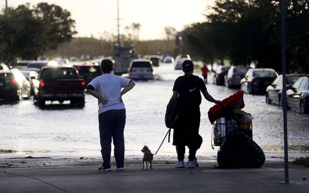 Evacuees on Monday leave Germain Arena, which was used as an evacuation shelter for Hurricane Irma in Estero, Florida. (AP Photo/Gerald Herbert)