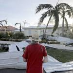Rick Freedman checks his neighbor&rsquo;s damage from Hurricane Irma in Marco Island, Florida, on Monday. (AP Photo/David Goldman)