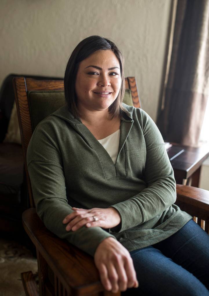 Nikki Oku sits in the living room of her home that will be featured in the Historic Everett 2017 Home Tour on Sept. 23. Oku and Tim Sonia have made an effort to update their home while also highlighting original features. (Ian Terry / The Herald)
