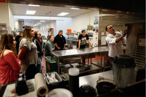 In culinary arts class at Sno-Isle Tech Center, Wednesday, instructor John Pence introduces new students to unusually large kitchen appliances, including the ovens, one of which he demonstrates at right. (Dan Bates / The Herald)