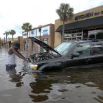 John Duke tries to figure out how to salvage his flooded vehicle in the wake Hurricane Irma on Monday in Jacksonville, Florida. (AP Photo/John Bazemore)