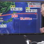 A man in Tokyo rides a bicycle past a public TV screen broadcasting news of North Korea&rsquo;s launch of missile on Friday. (AP Photo/Eugene Hoshiko)