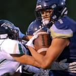 Arlington&rsquo;s Tallen Williams beats a tackle attempt by Marysville Getchell&rsquo;s Trey Padgett for a touchdown during a game on Sept. 15, 2017, at Arlington High School. (Kevin Clark / The Herald)