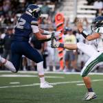 Arlington&rsquo;s Payton Bastien blocks Marysville Getchell&rsquo;s Caleb Wride&rsquo;s punt, recovers the ball and scores a touchdown during a game Sept. 15, 2017, at Arlington High School. (Kevin Clark / The Herald)