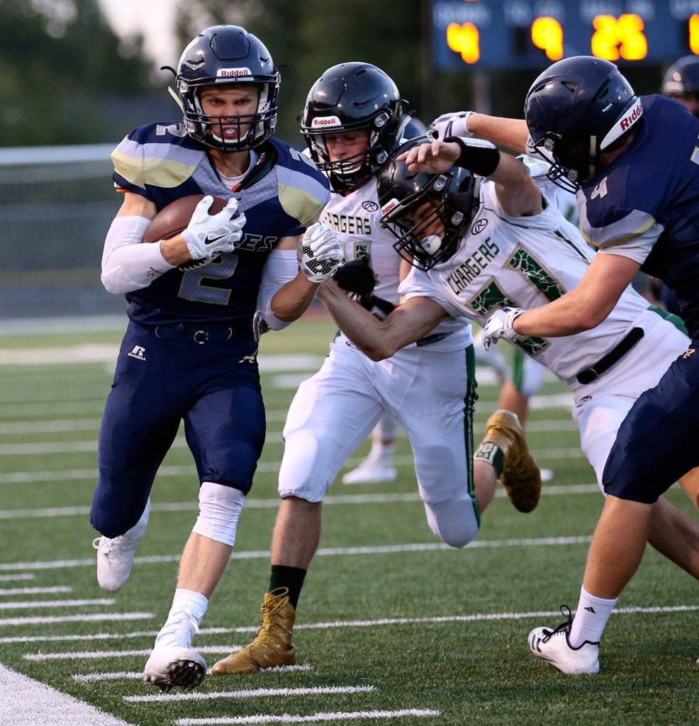 Arlington&rsquo;s Trevor Kazen hugs the sideline in route to the end zone and touchdown during a game on Sept. 15, 2017, at Arlington High School. (Kevin Clark / The Herald)
