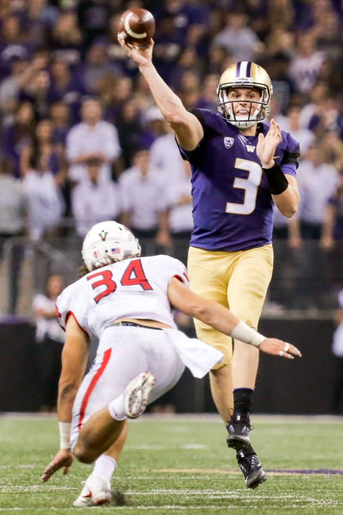 Washington&rsquo;s Jake Browning makes a pass with Fresno State&rsquo;s George Helmuth closing on Sept. 16, 2017, at Husky Stadium in Seattle. (Kevin Clark / The Herald)