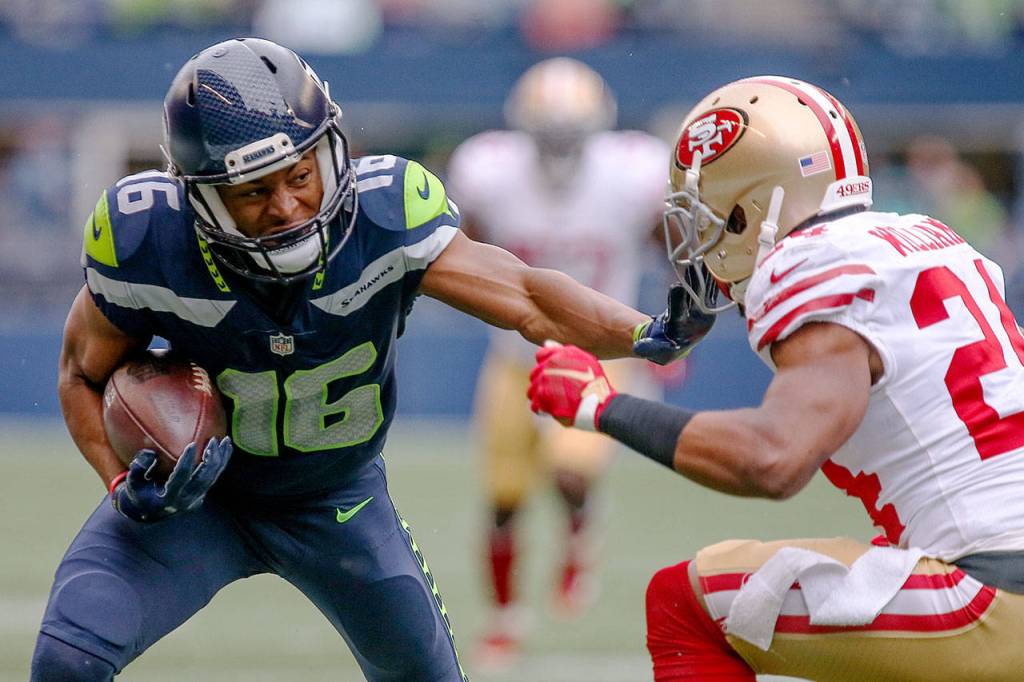 Seahawks wide receiver Tyler Lockett stiff arms 49ers corner back K&rsquo;Waun Williams Sunday afternoon at CenturyLink Field in Seattle on September 17, 2017. Seahawks defeated the 49ers, 12-9. (Kevin Clark / The Herald)