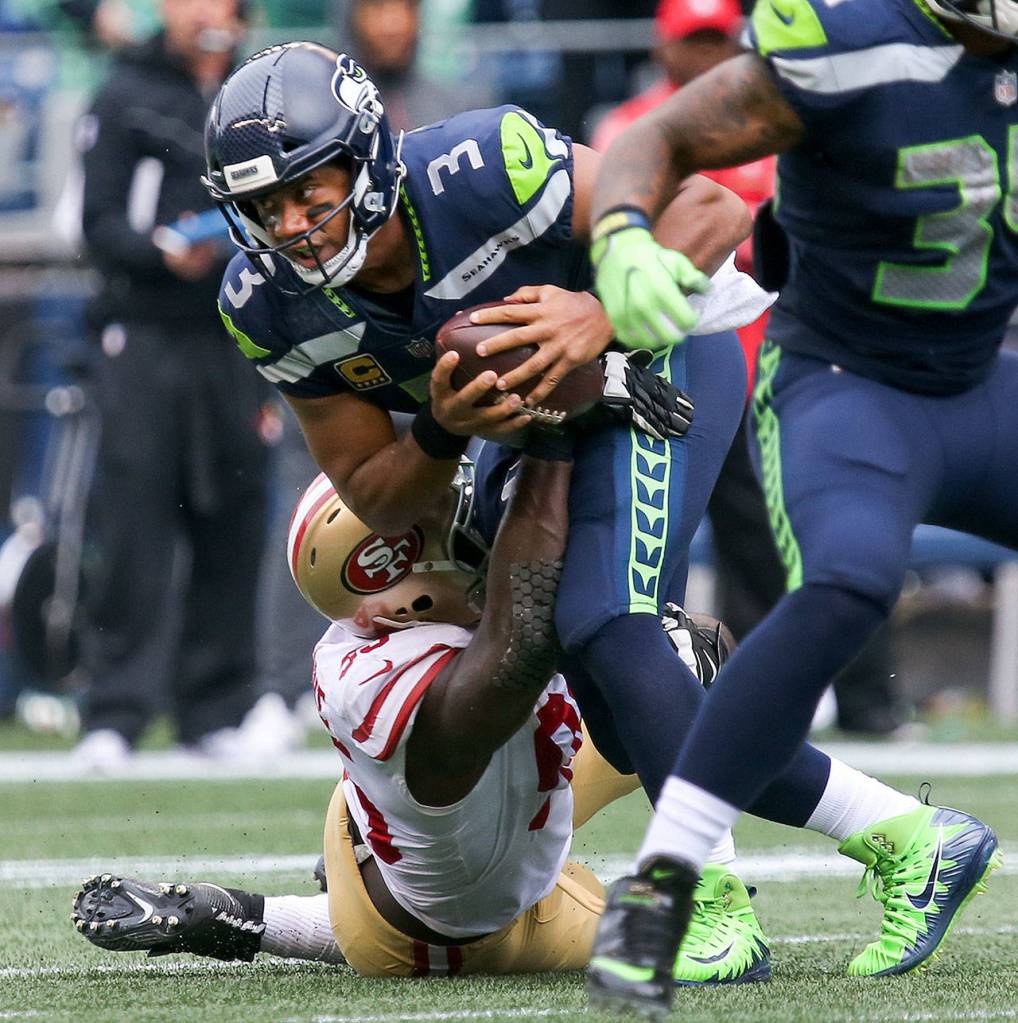 Seahawks quarterback Russell Wilson is sacked by 49ers defensive lineman DeForest Buckner Sunday afternoon at CenturyLink Field in Seattle on September 17, 2017. Seahawks defeated the 49ers, 12-9. (Kevin Clark / The Herald)