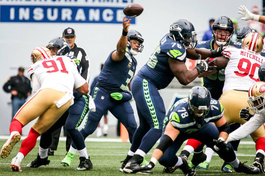 Seahawks quarterback Russell Wilson stands in the pocket attempting a pass against the 49ers Sunday afternoon at CenturyLink Field in Seattle on September 17, 2017. Seahawks defeated the 49ers, 12-9. (Kevin Clark / The Herald)
