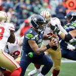 The San Francisco 49ers put pressure on Seattle Seahawks quarterback Russell Wilson (center) during the first half of Sunday&rsquo;s NFL game in Seattle. (AP Photo/Elaine Thompson)