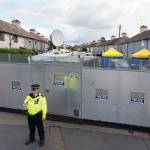 A police officer stands by a cordon on Monday in Sunbury-on-Thames, a London suburb where officials searched the home of a couple who fostered two suspects in last week&rsquo;s subway bombing. (Dominic Lipinski/PA via AP)