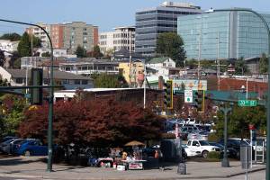 A customer walks away after buying a hot dog from a vendor on 33rd St and Smith Street near the Everett Station on Friday. The Everett Station District Alliance pictures the area east of Broadway and south of Hewitt Avenue as a future neighborhood and transit hub that could absorb expected population growth. (Andy Bronson / The Herald)