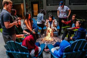Along with a few friends, student residents at Cedar Hall roast marshmallows, play Ping-Pong and talk around a fire in a secure open-air interior courtyard. (Dan Bates / The Herald)