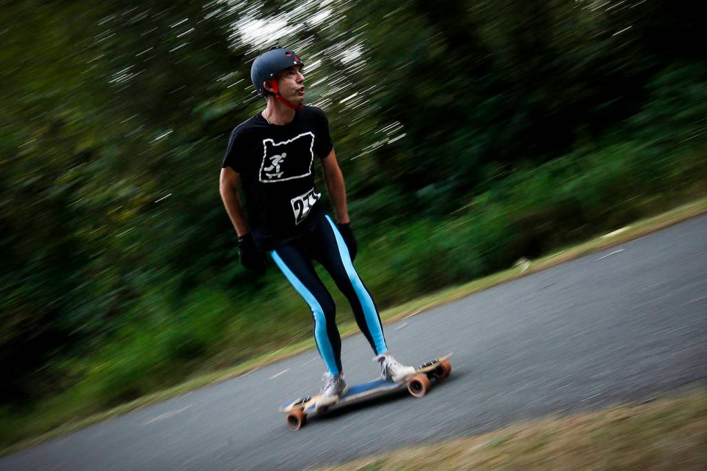 Phil Priestley, of Salem, cruises to the finish line of an 8.5 mile longboard race held on the Centennial Trail in Arlington on Saturday, Sept. 23. (Ian Terry / The Herald)