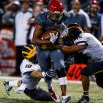 Archbishop Murphys Rwehabura Munyagi (center) is brought down by Bellevue defenders Drew Fowler (left) and Eric Son (right) during a game at Archbishop Murphy High School in Everett on Sept. 22, 2017. (Ian Terry / The Herald)