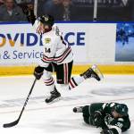Portlands Jake Gricius jumps to capture the puck over Everetts Kevin Davis on Saturday night at Xfinity Arena in Everett. (Kevin Clark / The Herald)