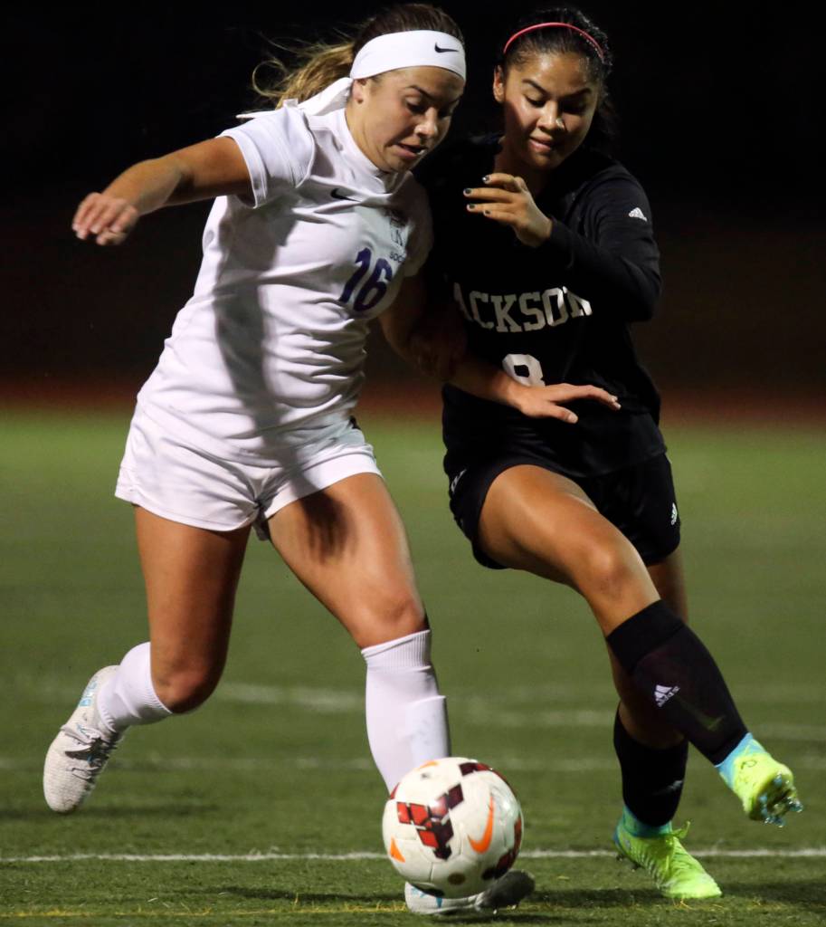 Kamiaks Kailin Wiley (left) and Jacksons Peyton Manalo vie for possession of the ball at Kamiak High School in Mukilteo on Sept. 19. (Kevin Clark / The Herald)