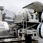 Alaska Airlines employee Jeff Ferguson loads cargo into the middle of a passenger plane at Ted Stevens Anchorage International Airport in Anchorage, Alaska. The airline is retiring its combi planes  Boeing 737-400s designed to carry both cargo and passengers. (AP Photo/Mark Thiessen)