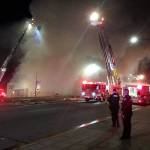 A building across Broadway from Xfinity Arena collapsed in a massive fire Monday night in downtown Everett. (Caleb Hutton / The Herald)