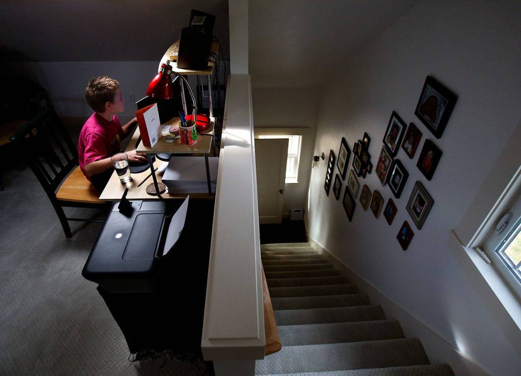 The Coghills 10-year-old son, Jack, works on a computer in a fully redesigned upstairs. (Dan Bates / The Herald)