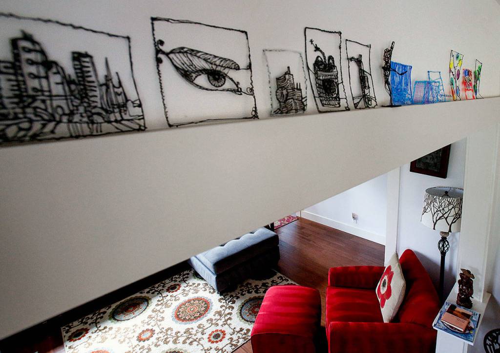The wooden moldings used in the remodel to retain the Coghill houses character provide a wide enough edge to support an art collection. (Dan Bates / The Herald)