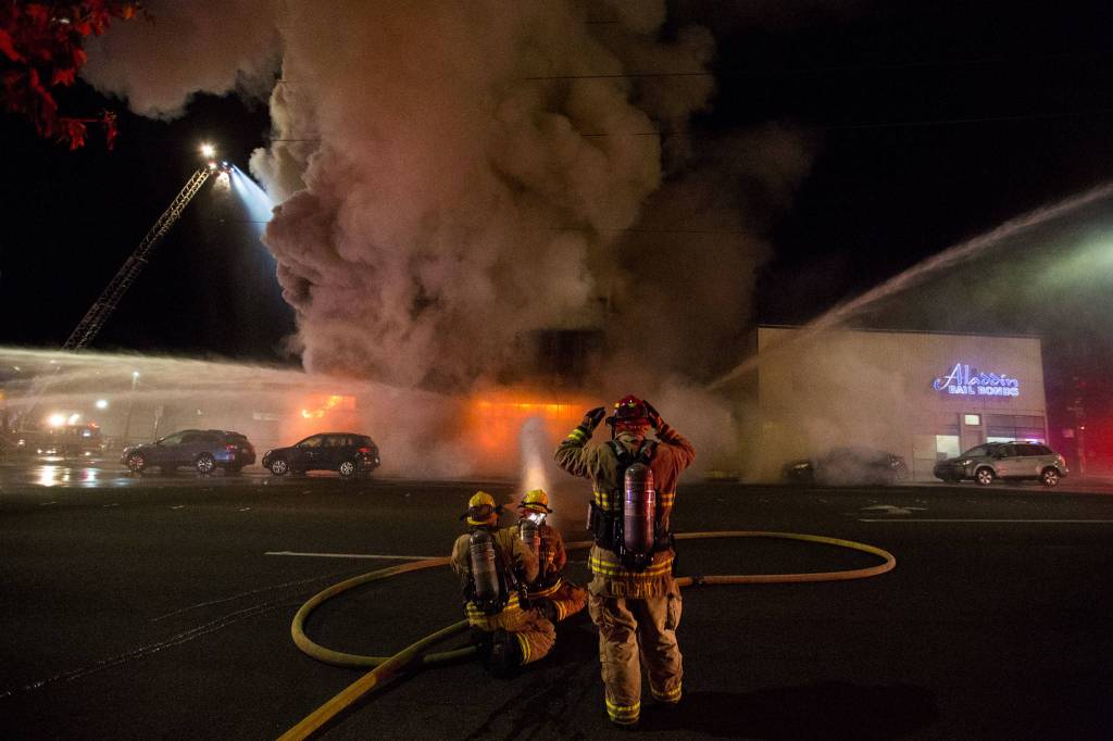 Firefighters add another hose to Mondays fire at Everett Office Furniture on Broadway. (Andy Bronson / The Herald)