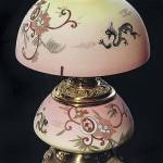 It took $3,335 to buy this student lamp with a font made of Mt. Washington Burmese glass. It is a stylish electrified lamp with an antique base and a shade made later and decorated to match. (Cowles Syndicate Inc.)