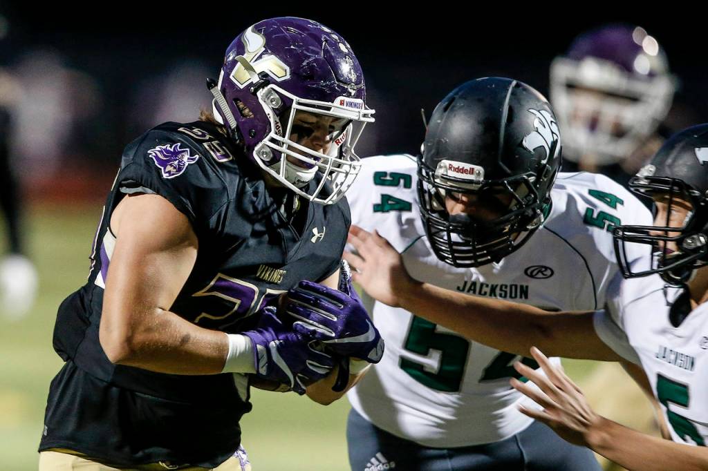 Lake Stevens Ryan Sander (left) comes down with an interception from a deflected pass on the first play of a game against Jackson on Sept. 29, 2017, at Lake Stevens High School. (Ian Terry / The Herald)