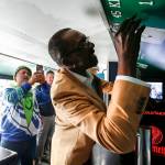 Former Seahawks safety Kenny Easley signs a fans bus during a ceremony held in his honor at Greater Trinity Academy in Everett on Sept. 30, 2017. (Ian Terry / The Herald)