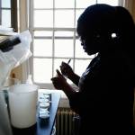 At NOAH in Mukileto, Akofa Kekeh, a 20-year-old intern from Virginia labels water quality samples used in studying the impact of ocean acidification on dungeness crab reproduction. (Dan Bates / The Herald)