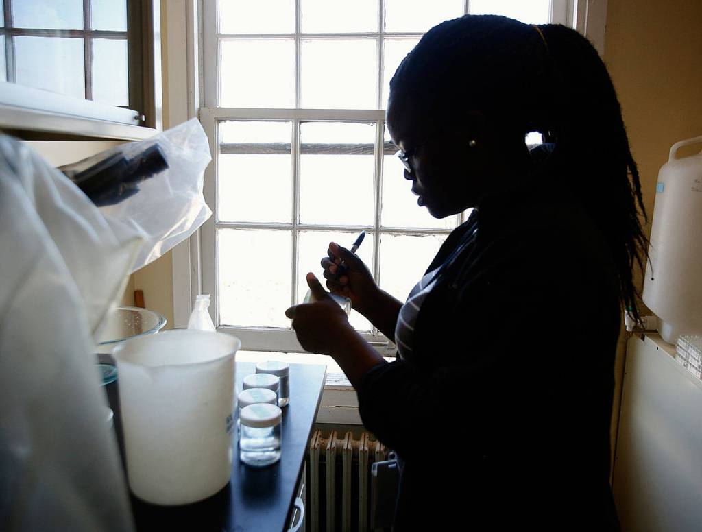 At NOAH in Mukileto, Akofa Kekeh, a 20-year-old intern from Virginia labels water quality samples used in studying the impact of ocean acidification on dungeness crab reproduction. (Dan Bates / The Herald)