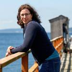 Shallin Busch takes a breather out on the pier at the NOAA facilites just north of the ferry terminal in Mukilteo. Busch conducts research on ocean acidification affects on marine species, including the Dungeness crab. (Dan Bates / The Herald)