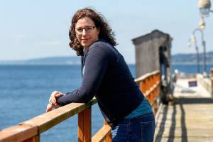 Shallin Busch takes a breather out on the pier at the NOAA facilites just north of the ferry terminal in Mukilteo. Busch conducts research on ocean acidification affects on marine species, including the Dungeness crab. (Dan Bates / The Herald)