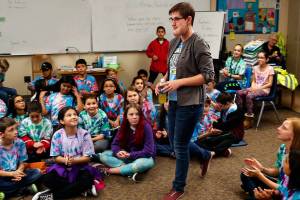 Abby Beauchamp, who was born with a facial condition that has brought her negative attention for much of her life, is introduced to a room filled with three classes of fifth-graders at Hillcrest Elementary School in Lake Stevens, Friday. The kids are reading the book Wonder, which is about a child with a similar condition. (Dan Bates / The Herald)