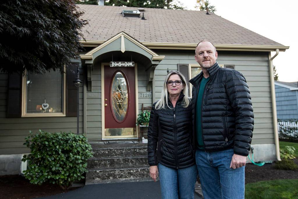 Jeff and Fran True stand in the driveway of their Beverly Boulevard home in Everett. (Ian Terry / The Herald)