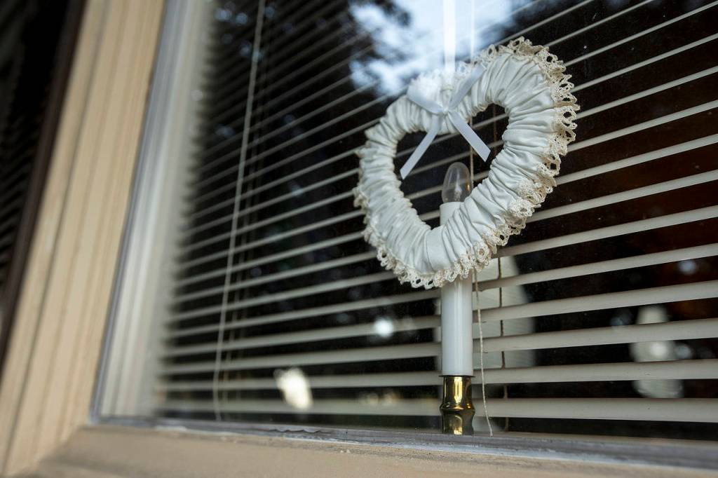 Hearts hang in each window of Jeff and Fran Trues Beverly Boulevard home in Everett. (Ian Terry / The Herald)